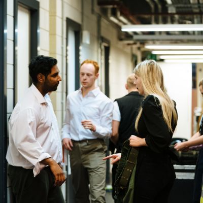Costume student speaking to actors backstage